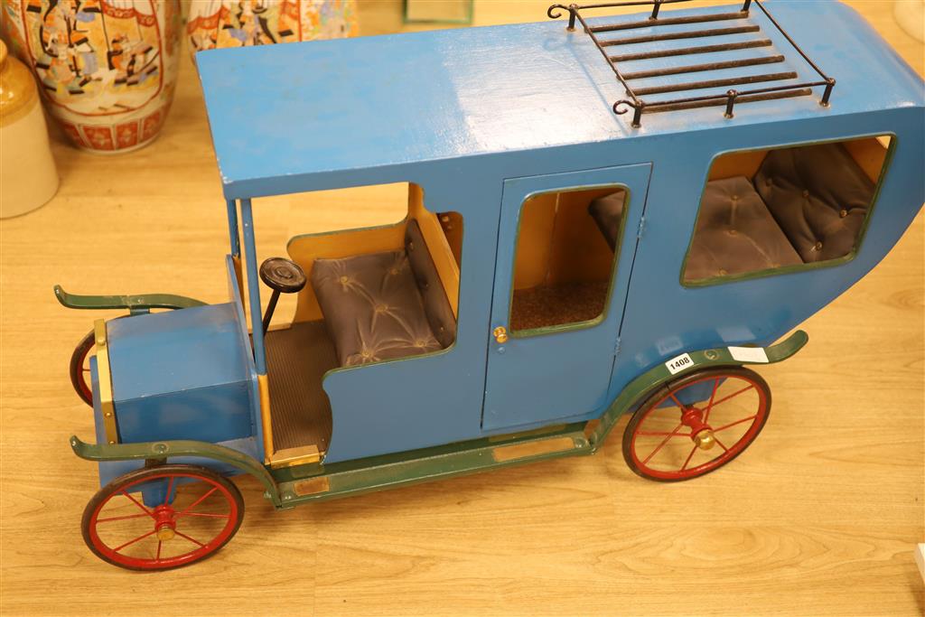 A novelty early 20th century model car, width 108cm height 62cm